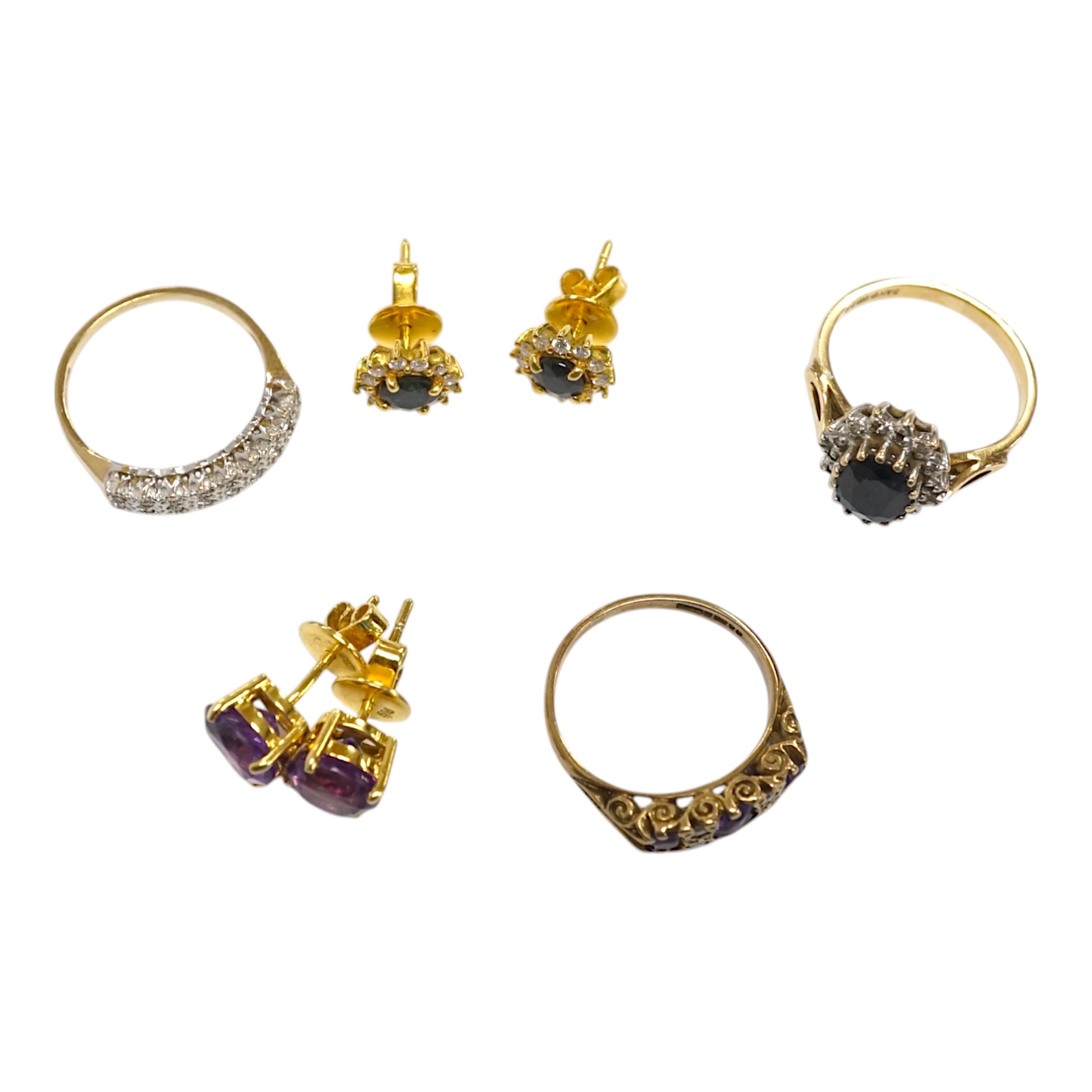 Three assorted 9ct and gem set rings including a diamond chip cluster half hoop and two pairs of yellow metal and gem set ear studs including sapphire? and diamond cluster. Condition - fair to good